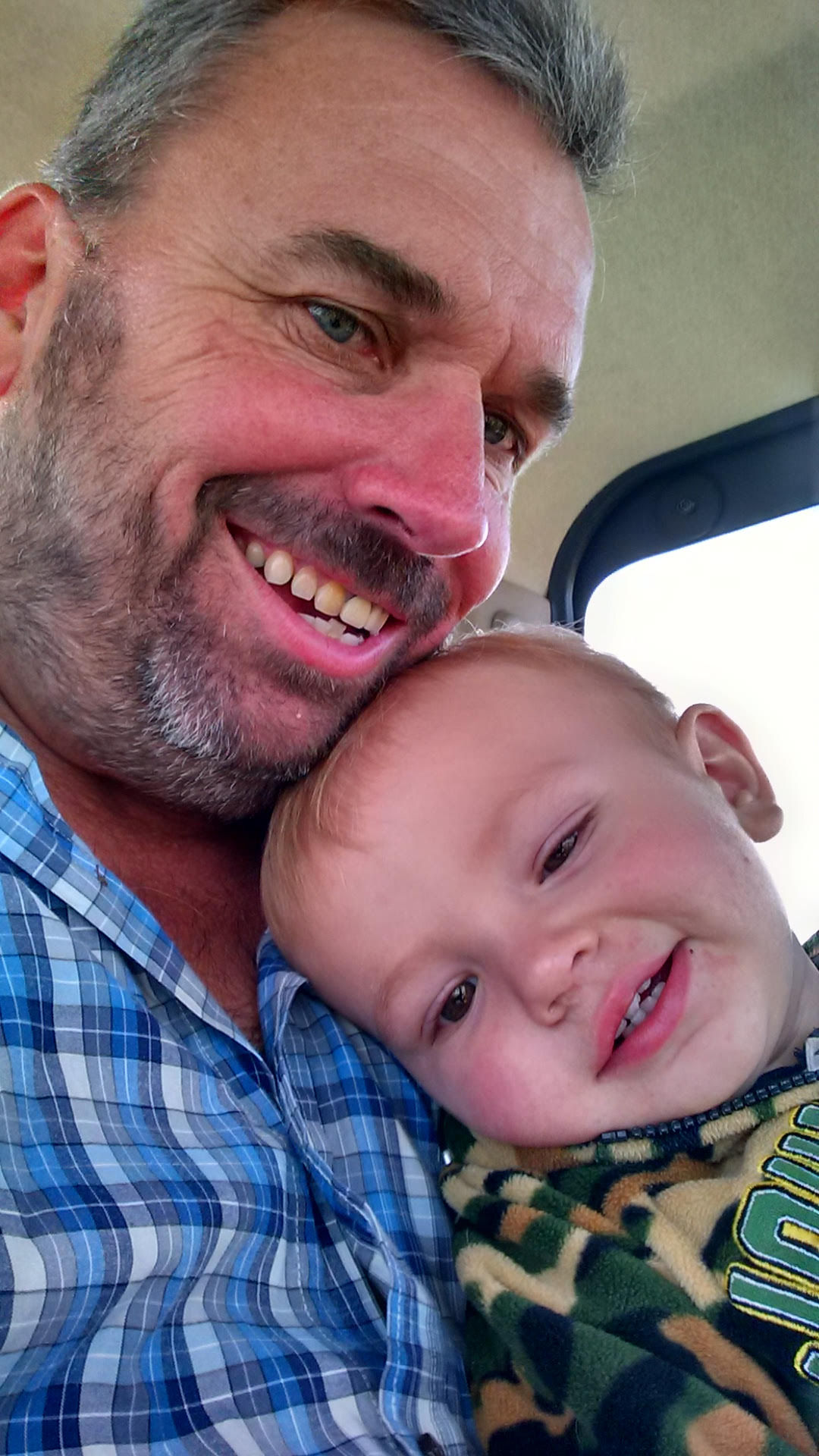 Me and my grandson driving a combine on our farm.